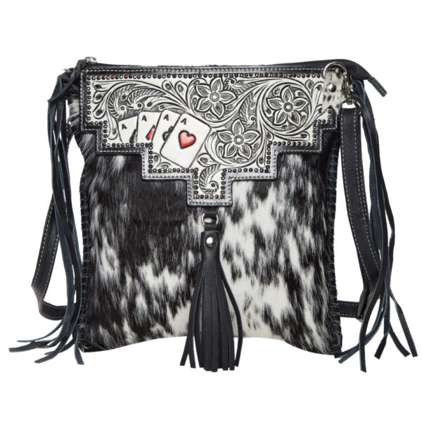 Chillan Tooling Leather Cowhide Sling Bag with Playing Cards Paint Highlight. Black and white cowhide leather handbag with decorative panel and tassels on a white background