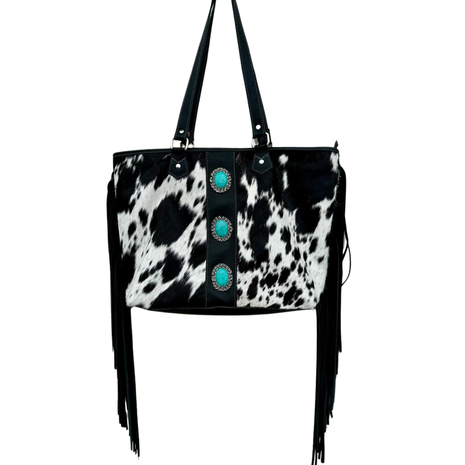 Women's Big Cowhide Bag With Turquoise Stonework and Fringes. A cowhide handbag featuring turquoise stonework and fringes on the sides. It has a black and white patterned cowhide leather exterior, multiple shoulder straps, and is displayed in a flat position.