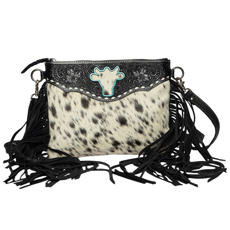 Women's Marbella Bullhead Cowhide Sling Bag with Fringes. Handbag with cow print and fringe details on a white background