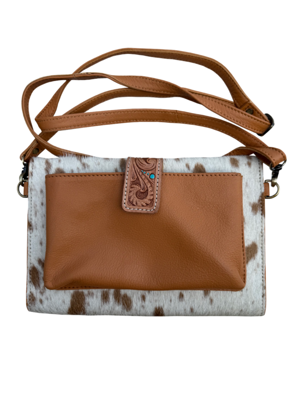 Cowhide Sunflower Tooling Leather Wallet Bag. Brown leather and cowhide patterned handbag with decorative clasp on a white background