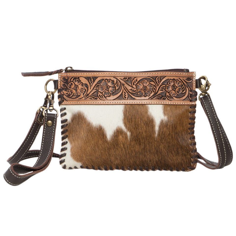 Volcan Brown Tooling Leather Cowhide Small Clutch Bag. Brown and white cowhide leather handbag with intricate tooled design on a white background