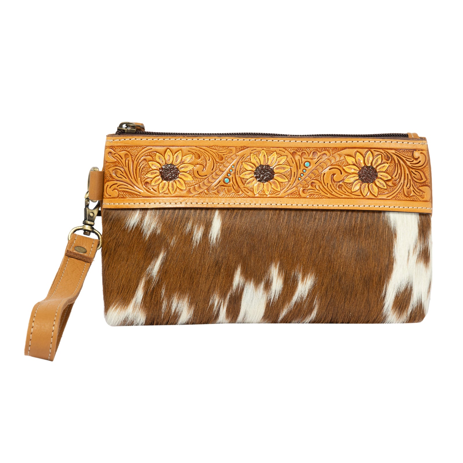Brown and white cowhide clutch with floral tooled leather top on a white background