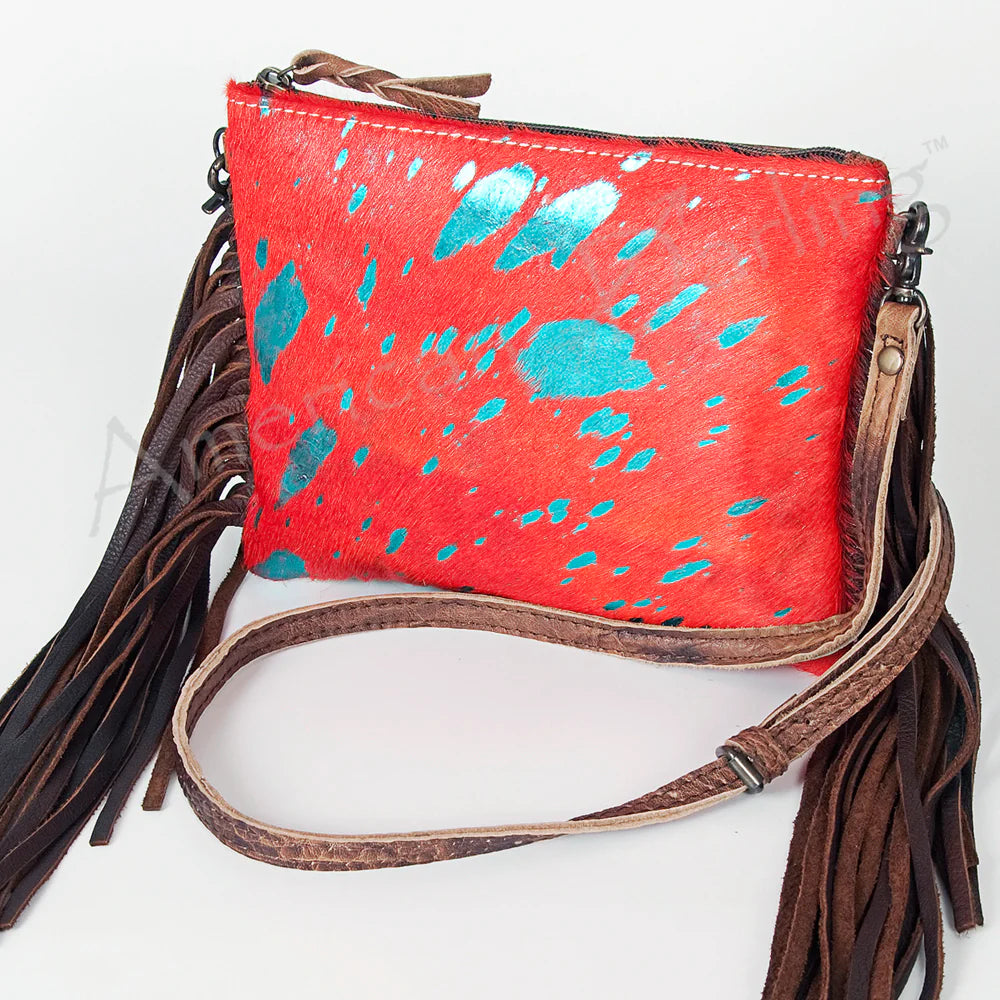 American Darling Western Olivia Hide Crossbody Bag. Red handbag with blue speckles and brown fringes on a white background