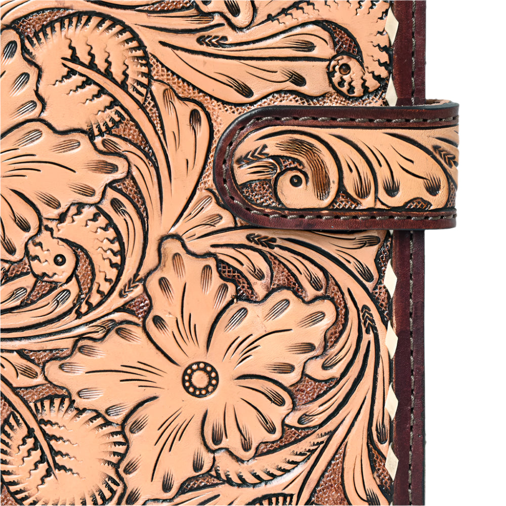 Close-up of a American Darling leather-bound journal with intricate floral patterns