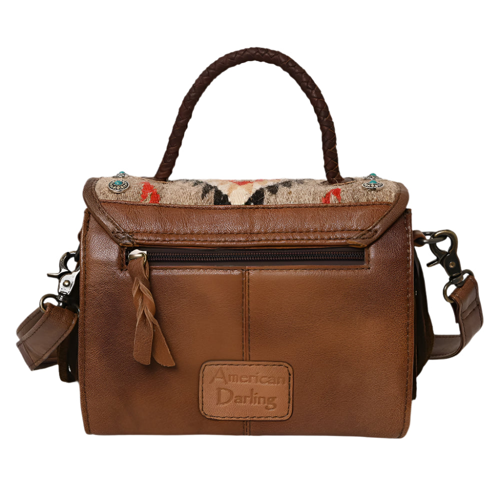 American Darling  brown leather crossbody bag with a western saddle blanket design, featuring fringe detailing and a shoulder strap.