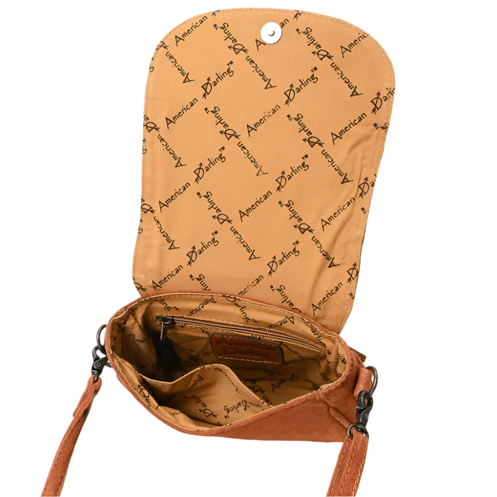 Inside of suede brown leather bag with 'American Darling' text pattern on a white background