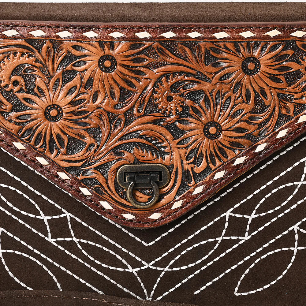 Close up of an American Darling suede brown women's envelope handbag with floral embossing and a shoulder strap.