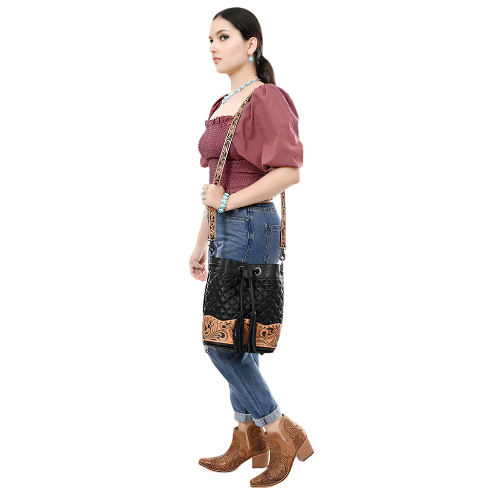 American Darling Black quilted leather western style bucket bag with intricate brown tooled leather strap on a white background