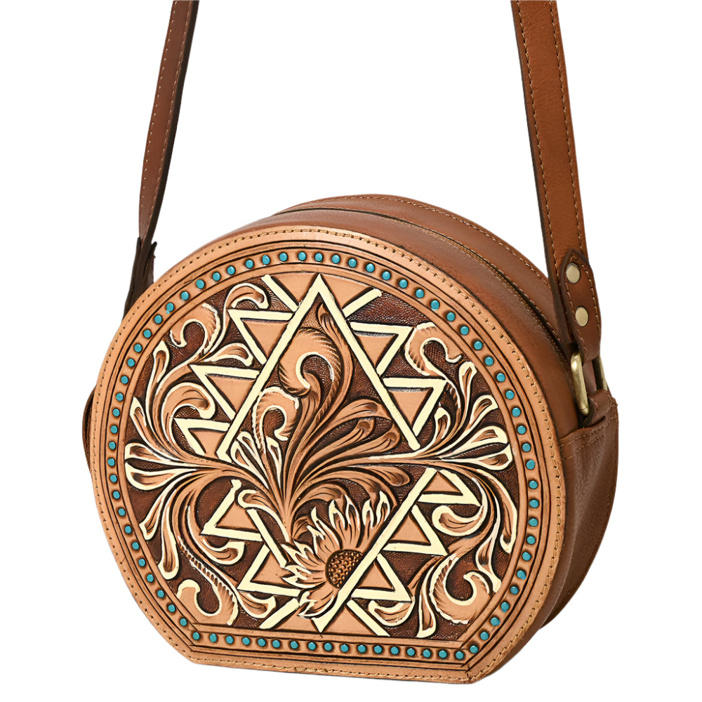 American Darling brown, circular, tooled leather western handbag with floral patterns and a shoulder strap.
