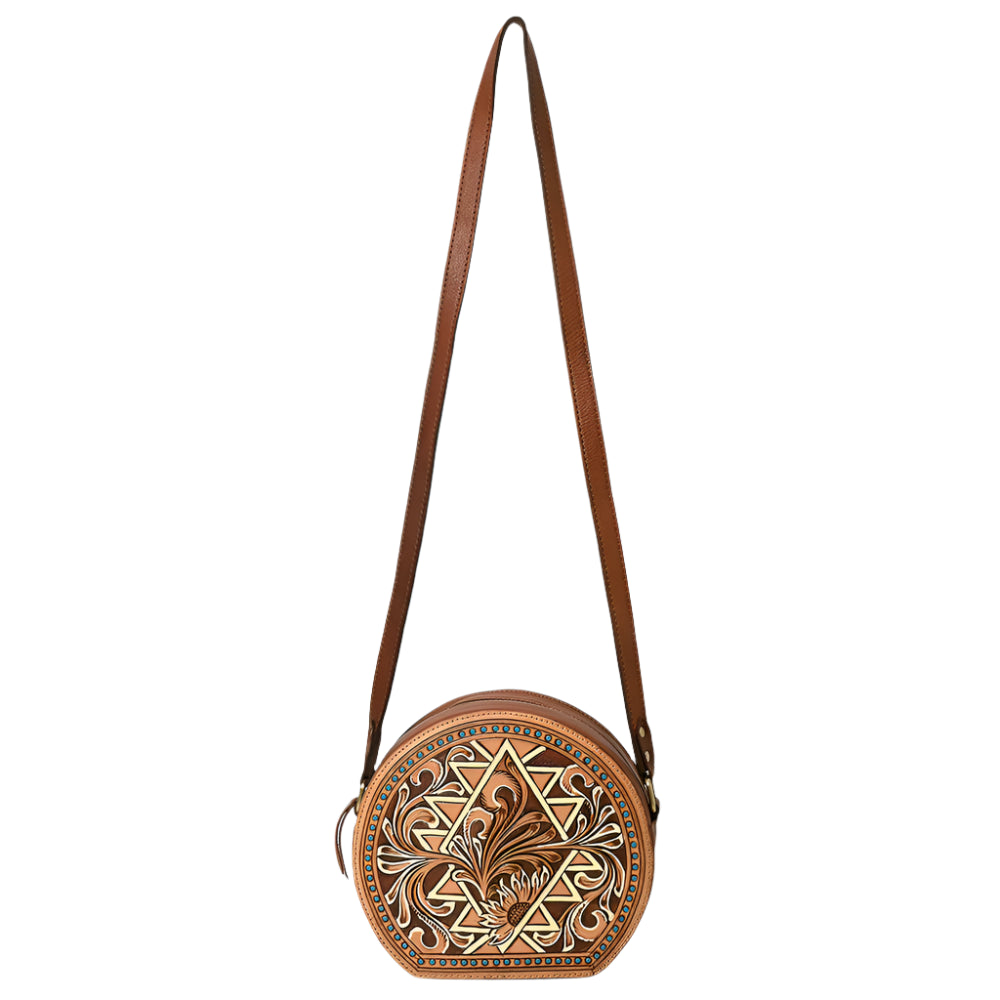 American Darling brown, circular, tooled leather western handbag with floral patterns and a shoulder strap.