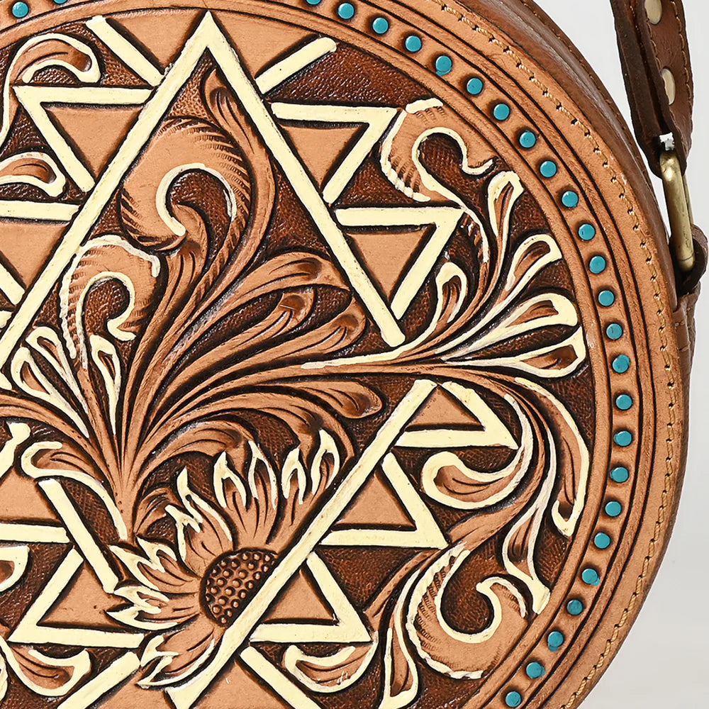 American Darling brown, circular, tooled leather western handbag with floral patterns and a shoulder strap.