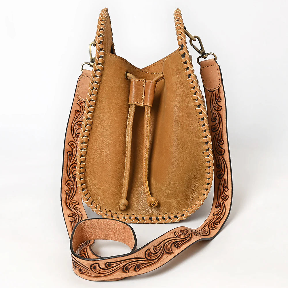 American Darling Western Floral Tooled Leather Sling Bag. Brown leather bag with intricate designs on a white background