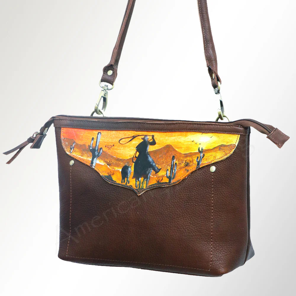 American Darling Hand-Painted Crossbody Western Handbag. Brown leather handbag with a desert scene design on a white background