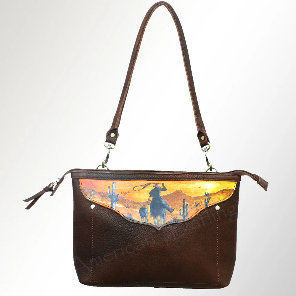 American Darling Hand-Painted Crossbody Western Handbag. Brown leather handbag with a scenic design on a white background