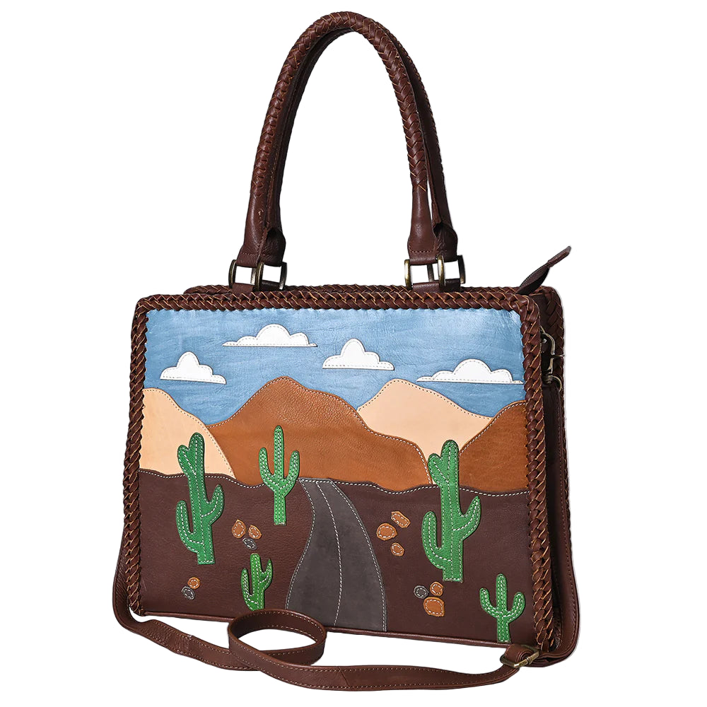 American Darling Desert Road Applique Western Tote. Handbag with desert landscape design featuring cacti and mountains on a white background