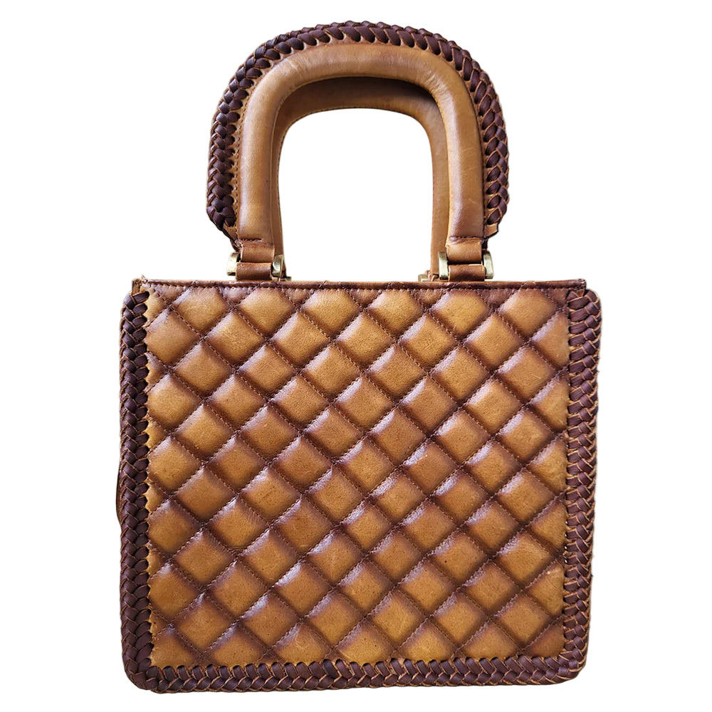 American Darling Quilted Barrel Leather Tote Bag. Brown quilted handbag with braided handle on a light background
