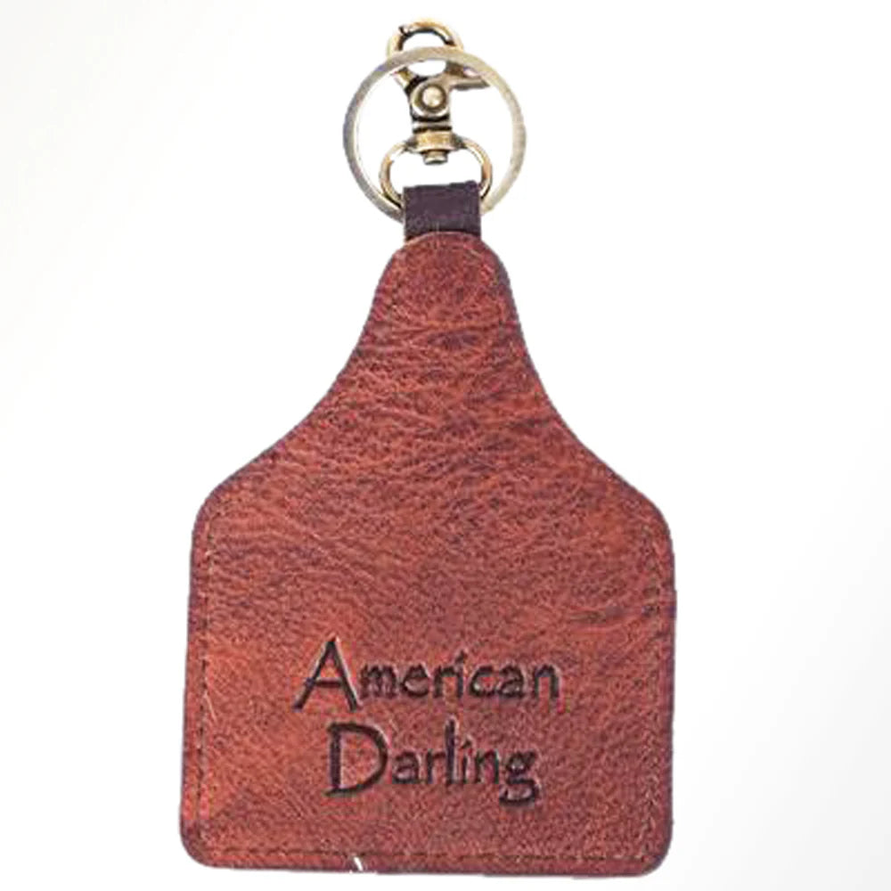 American Darling Keychain with a printed design of a person on bull on a white background