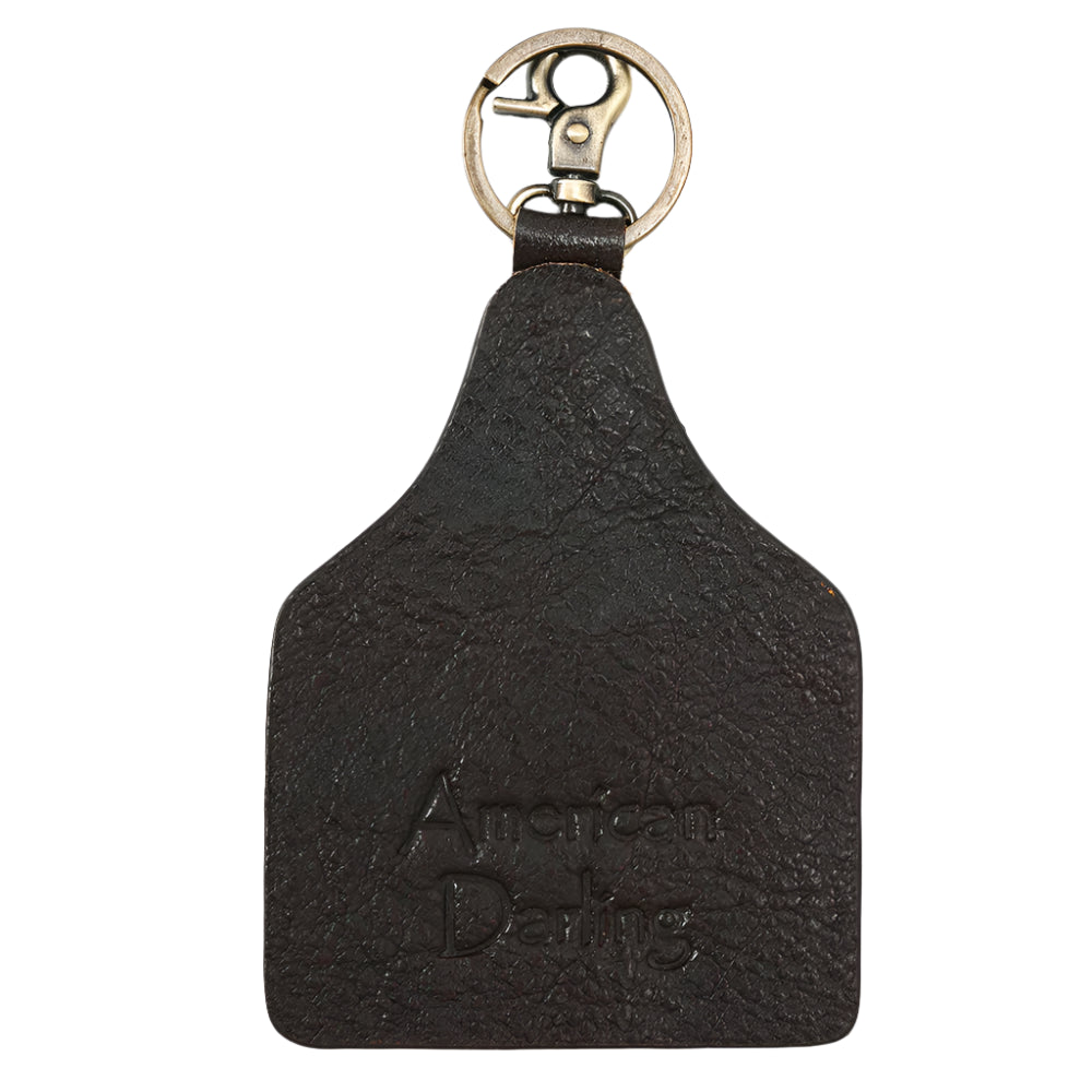 American Darling Leather keychain with a painted design of a teepee and cactus on a white background