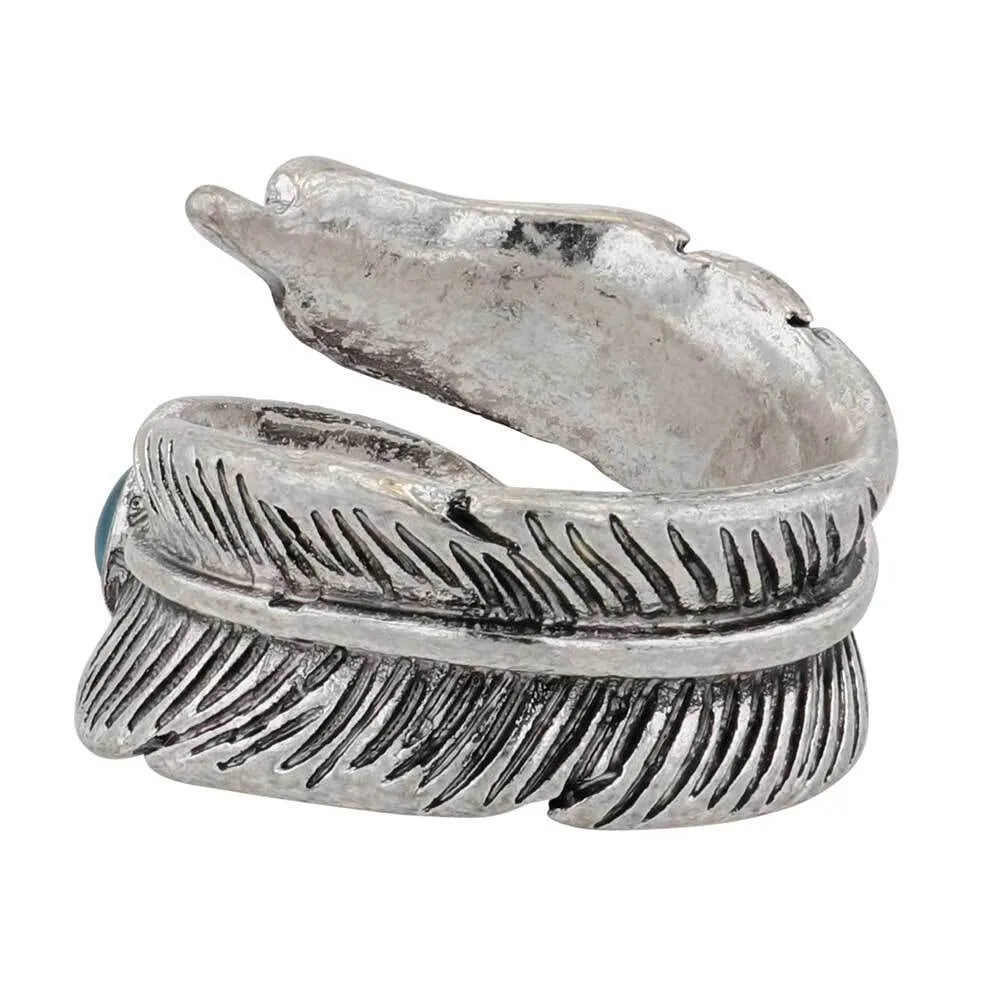 Montana Silversmiths Feather Touch Attitude Wrap Ring. A silver-colored metal ring with a feather design and a turquoise stone at the top, against a white background.