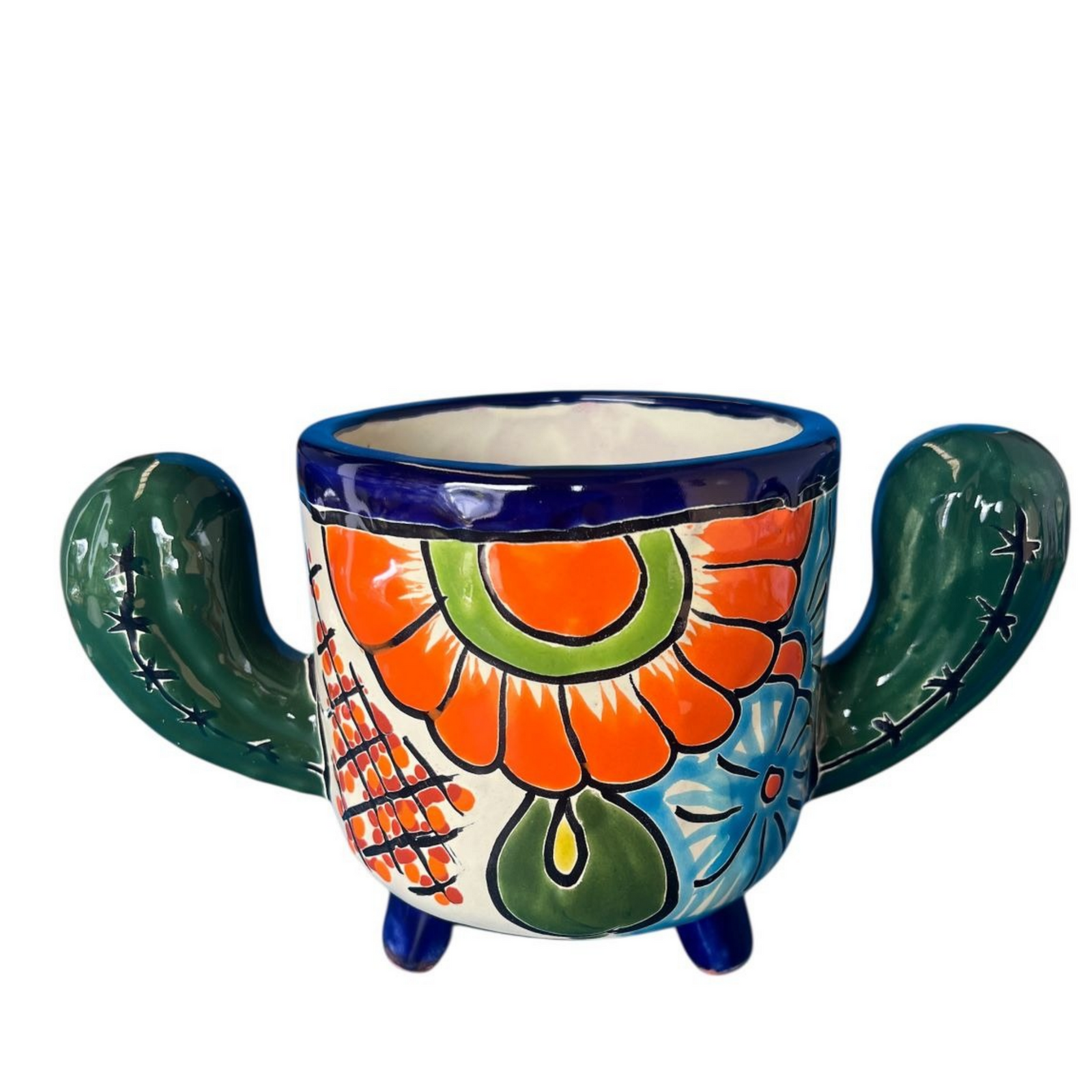 A hand-painted ceramic planter shaped like a cactus, featuring a white base decorated with a large orange flower, green leaves, blue accents, and dark green cactus arms with black stitched details, set against a plain white background.