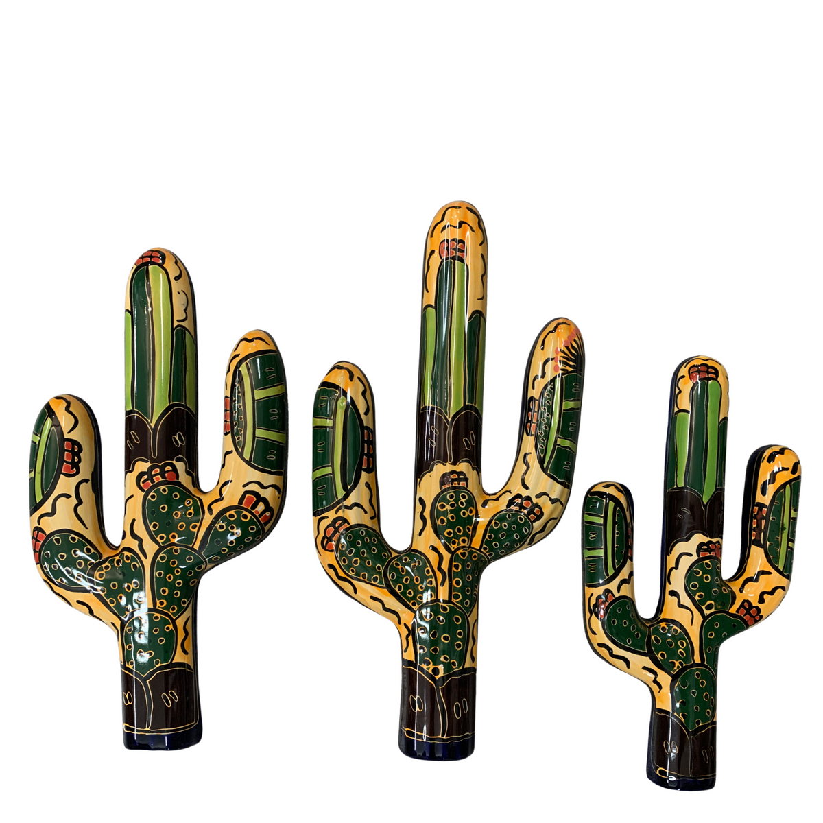 Three hand-painted ceramic cactus figurines in different heights, decorated with green, yellow, black, and red patterns on a plain white background.