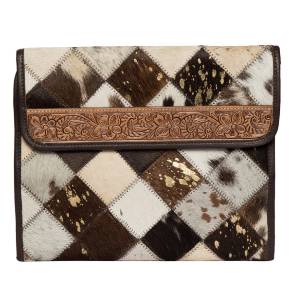 Women's Patchwork Cowhide and Tooling Leather Makeup Bag. Clutch bag with cowhide pattern and decorative brown leather trim on a white background