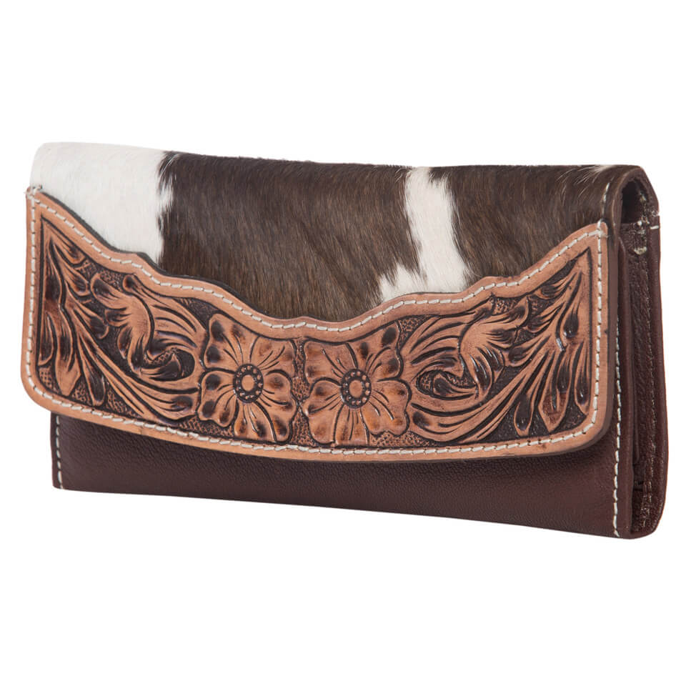Women's Oran Cowhide Wallet. A brown and white cowhide tri-fold wallet with floral hand tooled details and a magnetic button closure.