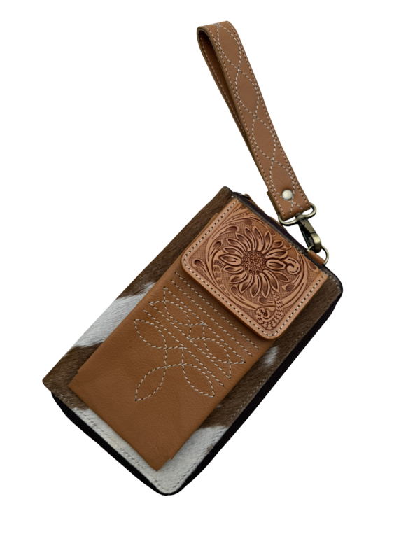 Tooling Leather Cowhide Boot Stitch Clutch Wallet. Brown leather wallet with floral embossing and wrist strap on a white background