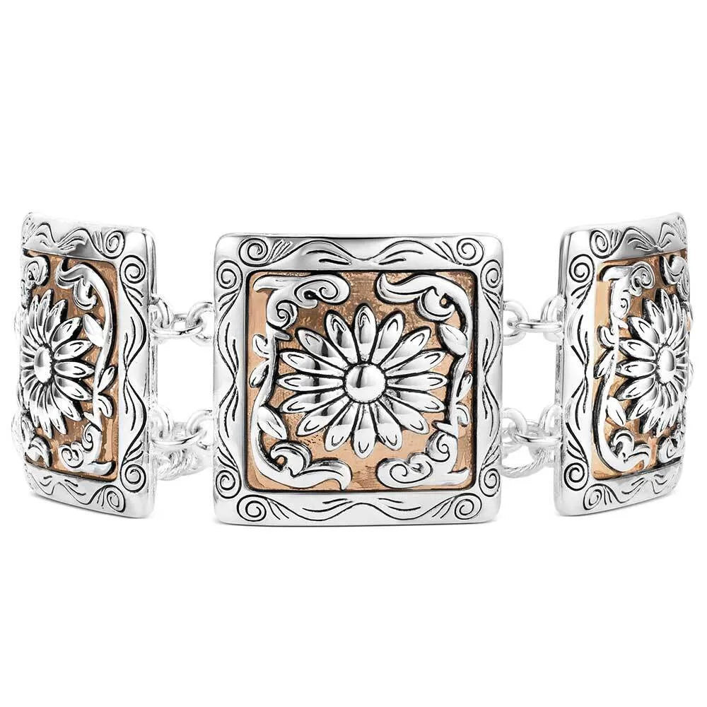 Silver and rose gold bracelet with floral designs on a white background