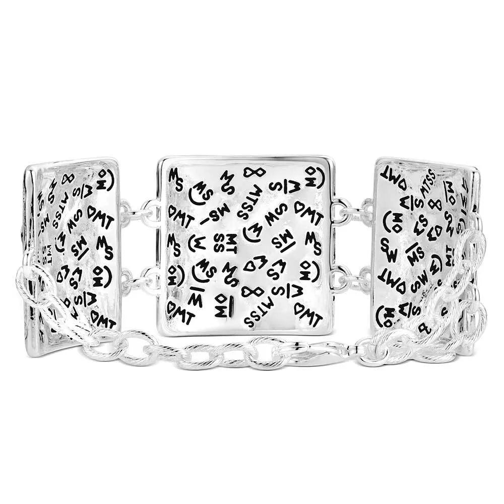 Silver bracelet with engraved pattern on a white background