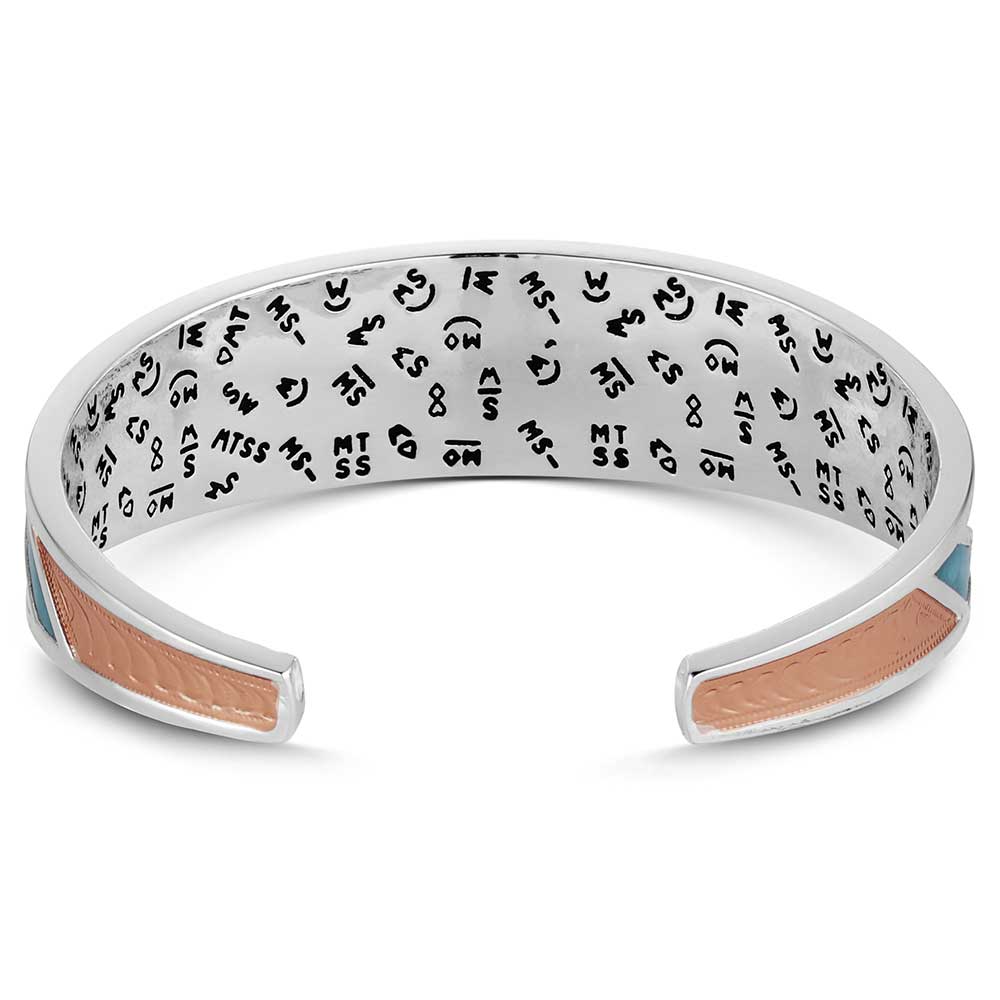 Silver bracelet with engraved text and pink interior on a white background