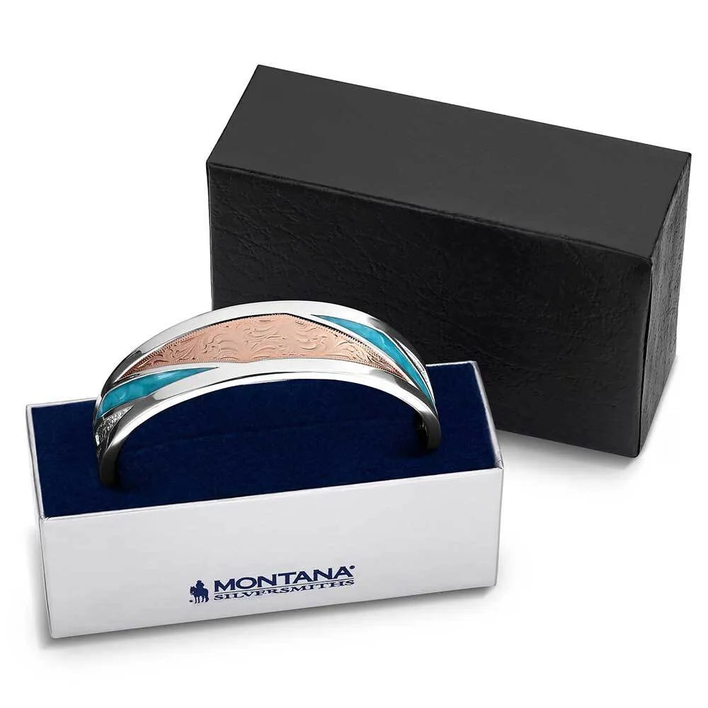 Silver and rose gold bracelet with blue accents in a Montana Silversmiths box.