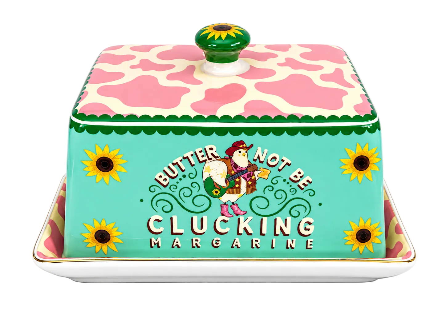 A decorative ceramic butter dish with a lid, featuring a turquoise front panel with the text 'BUTTER NOT BE CLUCKING MARGARINE' and a cartoon duck character, topped with a pink and cream cow-print lid and a green sunflower knob, shown on a white background.
