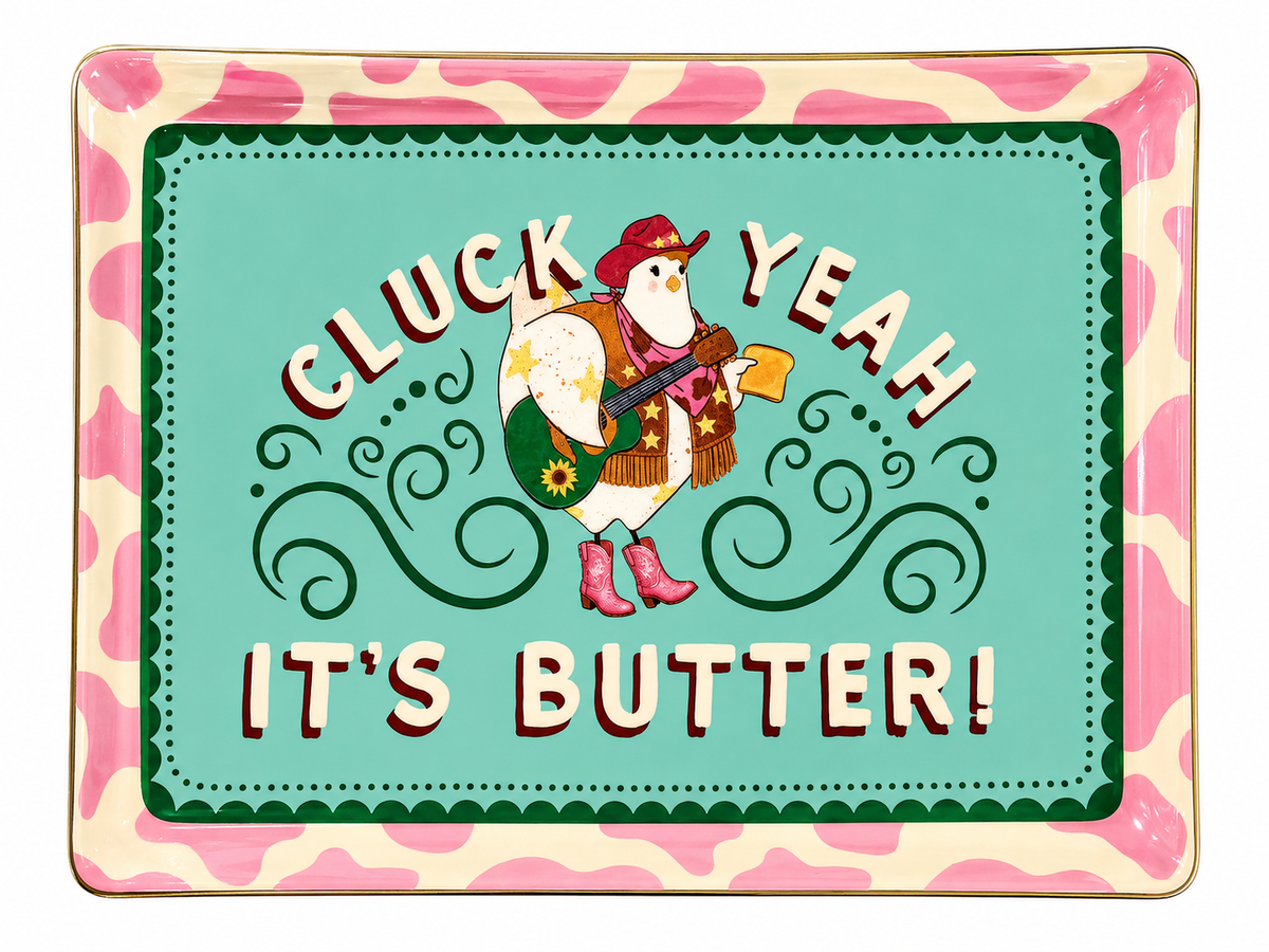 A square decorative tray with rounded corners featuring a colorful illustration of a chicken in western wear and the text 'CLUCK YEAH IT'S BUTTER!' on a mint green background, surrounded by a pink and cream cow-print border.