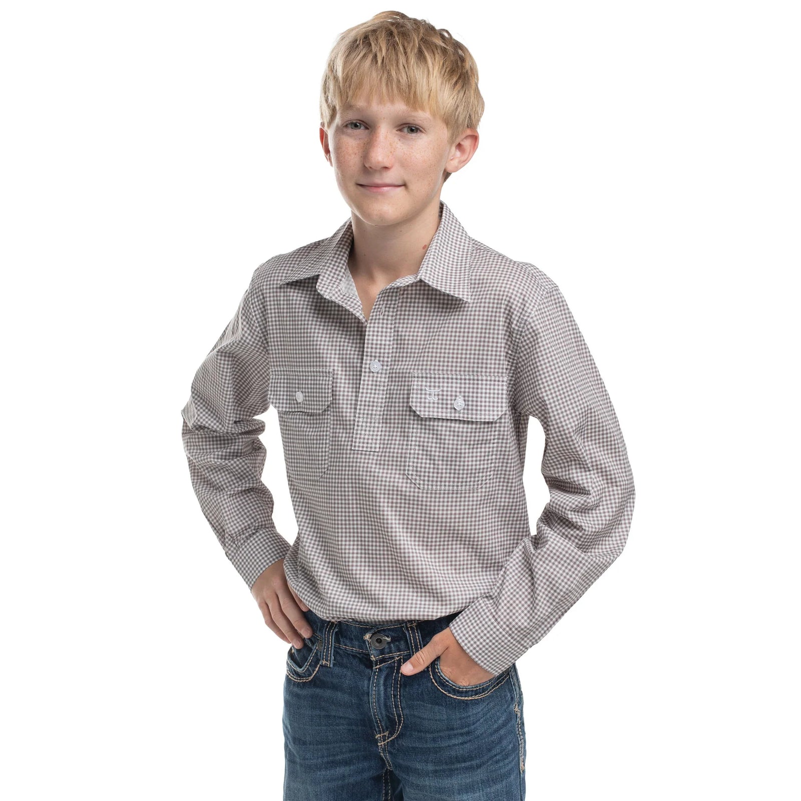 Young boy wearing a checkered shirt and jeans on a white background