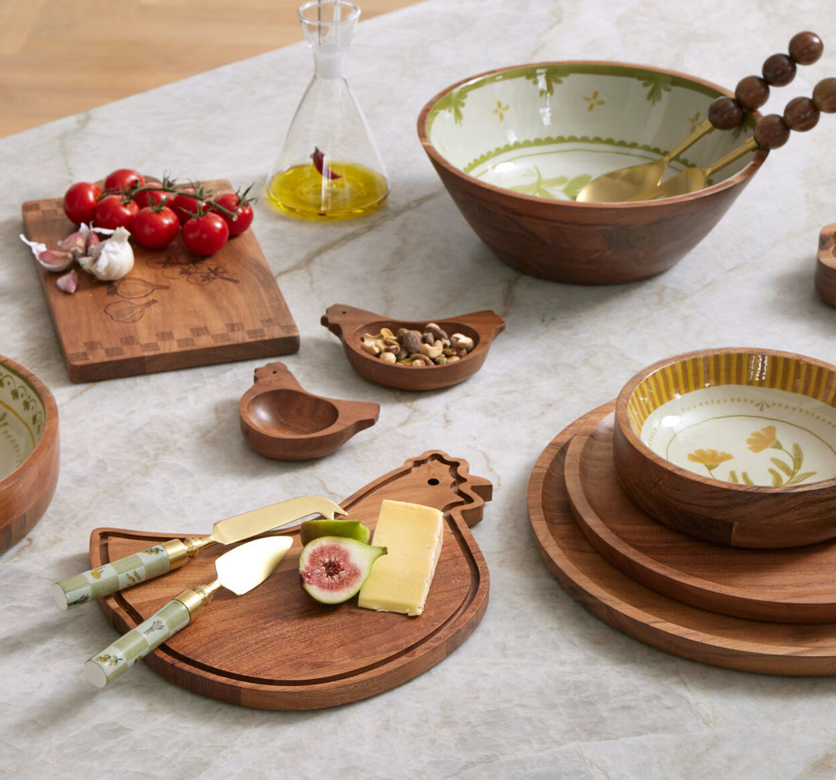 Wooden kitchen utensils and dishes on a marble surface