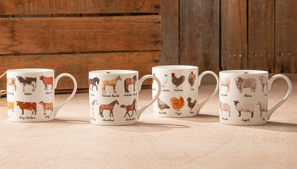 Four mugs with animal illustrations on a wooden surface and background