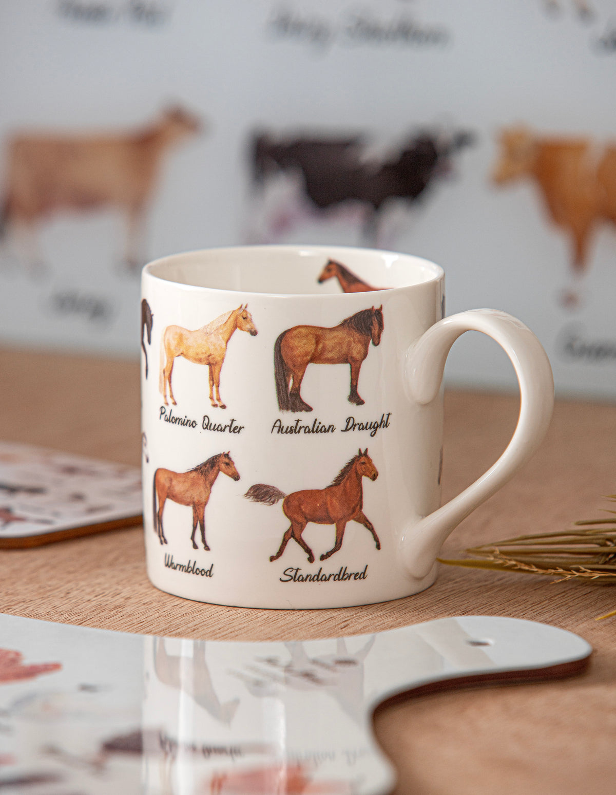 Mug with horse illustrations and text on a wooden surface