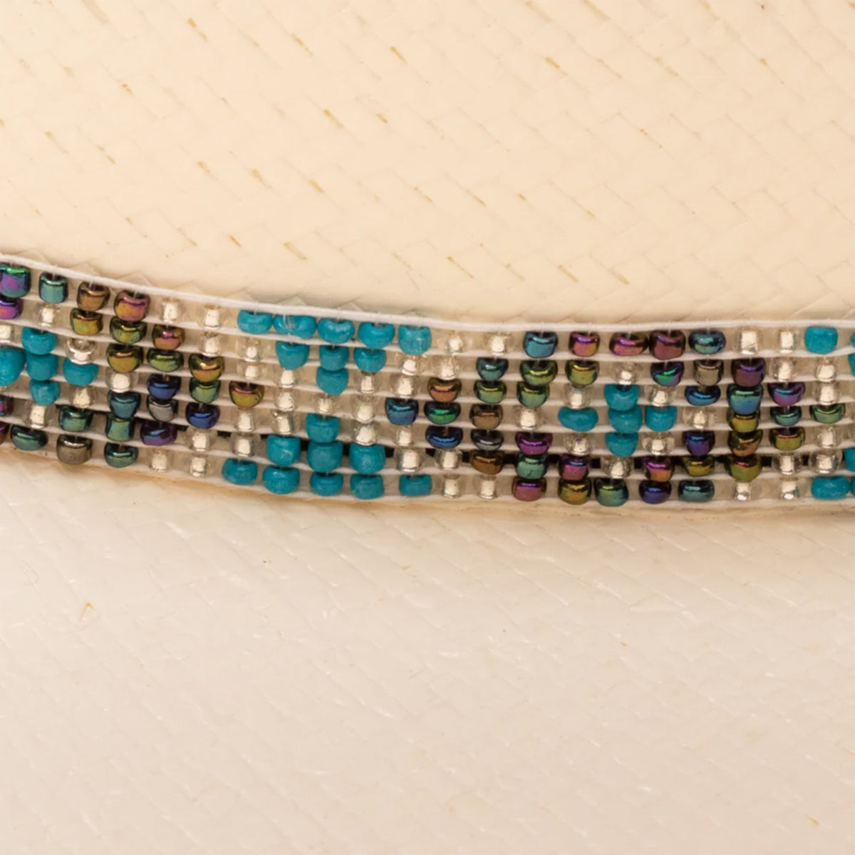 Charlie 1 Horse Apache Jr Straw Hat. A youth-sized beige Charlie 1 Horse Apache Jr straw hat with a cattleman's crown and a 4-inch brim. It features a beaded hatband with a diamondback pattern, blue whip stitching on the brim, and a brand logo on the front.