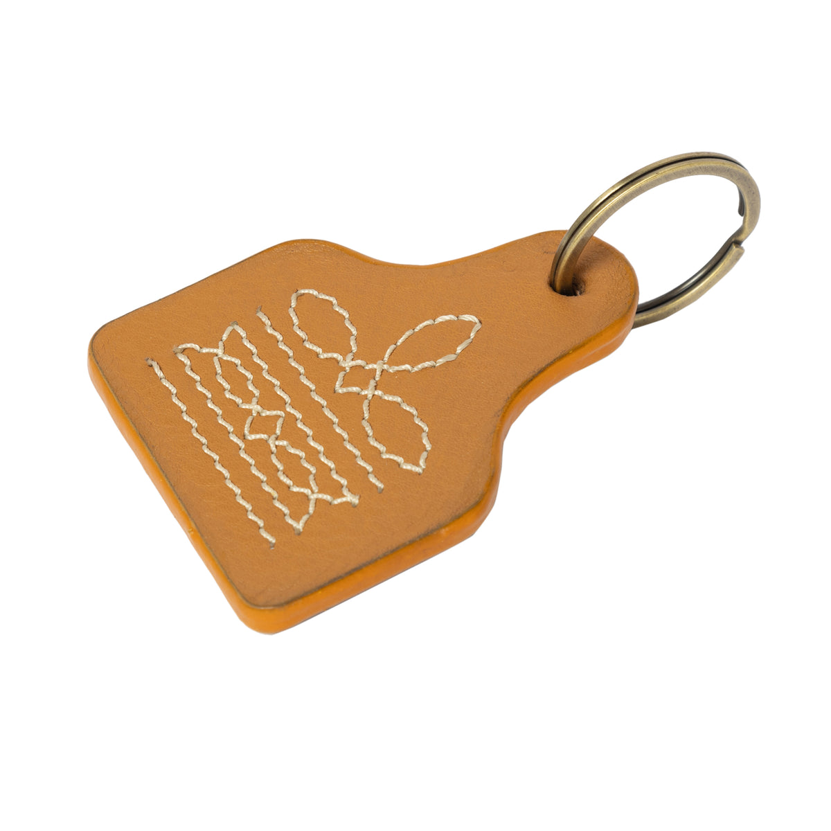 Brown leather keychain with white embroidered design on a white background
