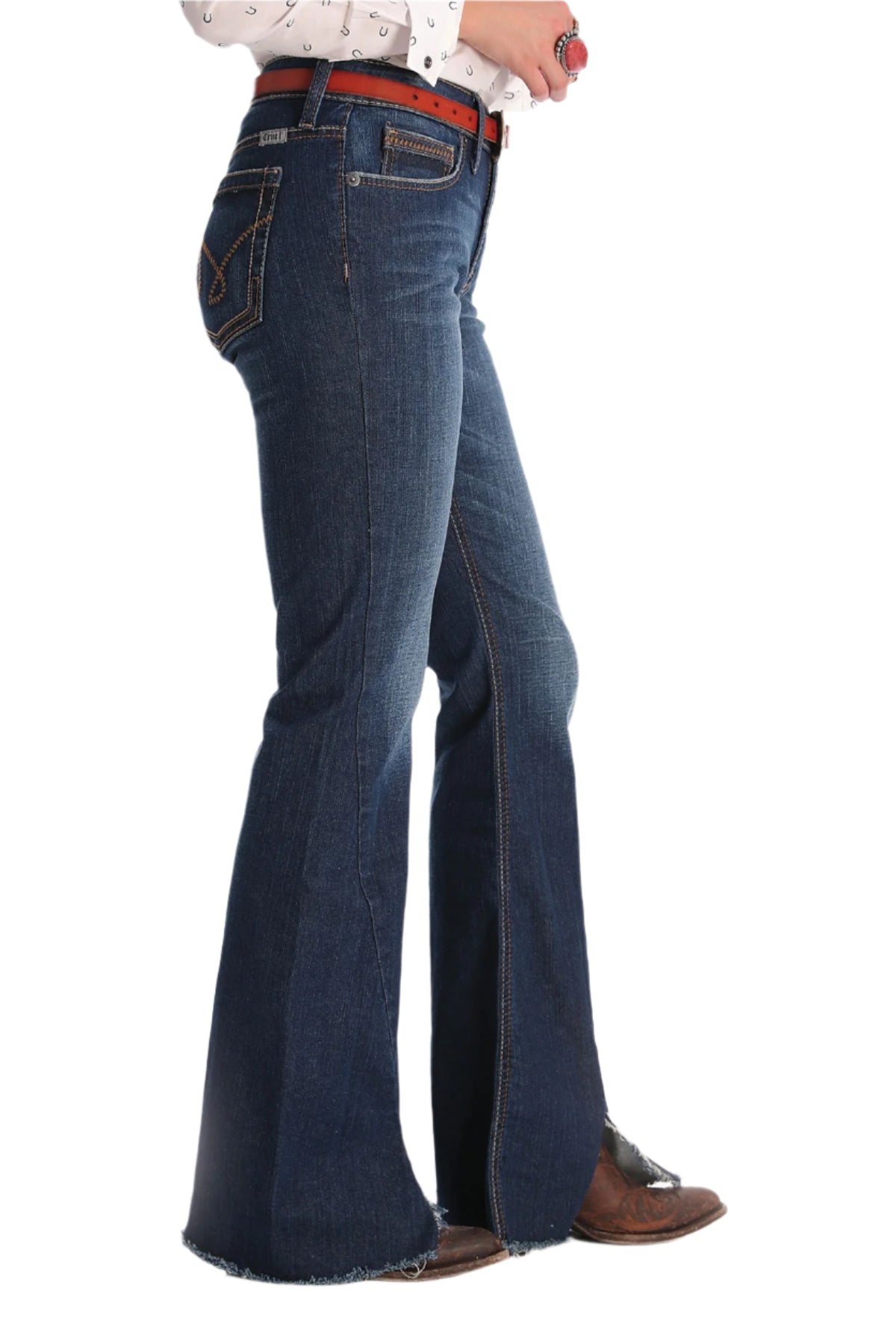Cruel Denim Women's Hannah Slim Fit Jean. Person wearing blue flared jeans with a white shirt on a white background