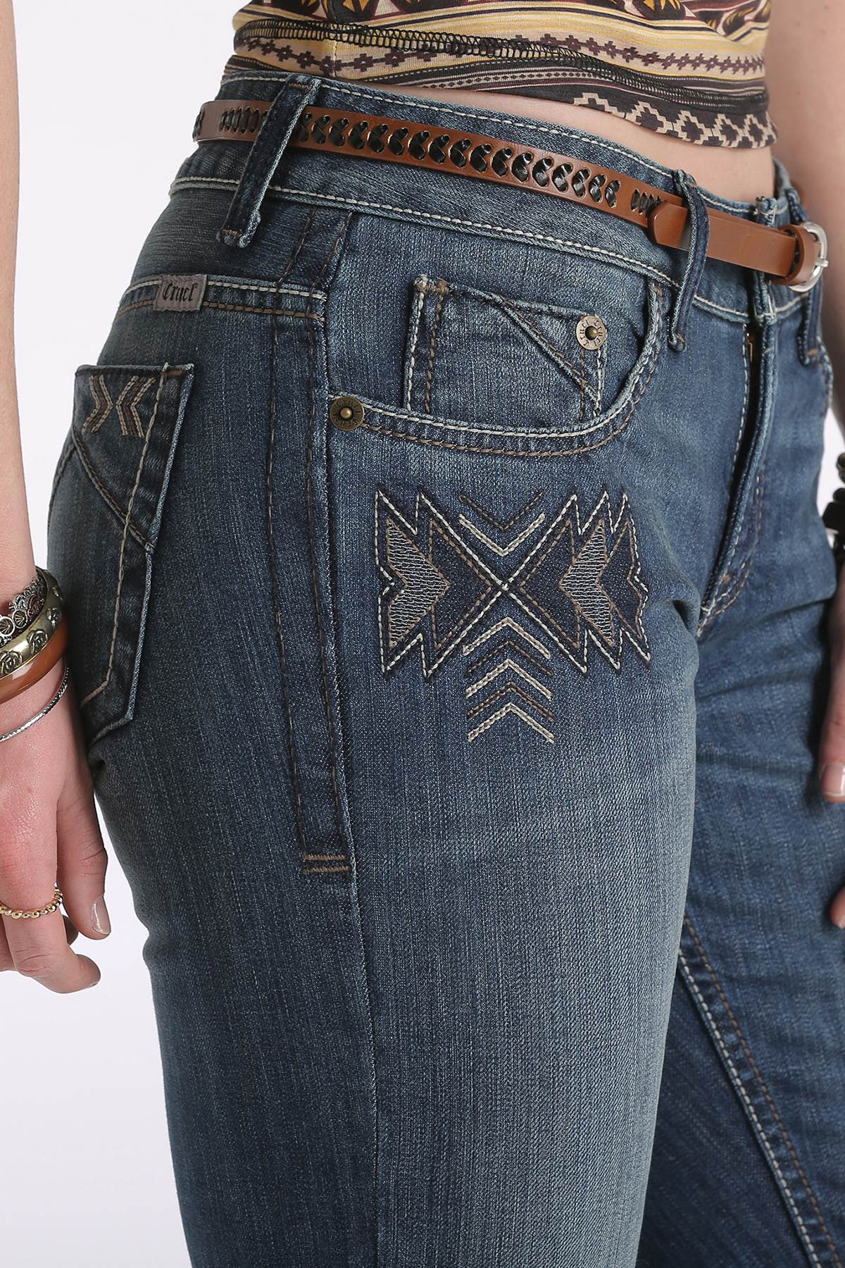 Cruel Denim Women's Abby Trend Jean. Close-up of blue jeans with geometric embroidery on a white background