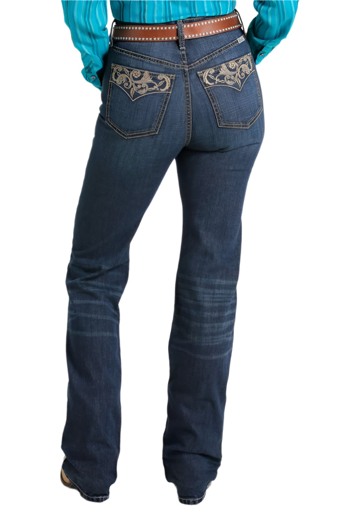 Cruel Denim Women's Skylar Sky-High Jean. A pair of women's blue denim jeans with a high waist, 5 pocket design, and boot cut leg, featuring decorative embroidery on the back pockets.