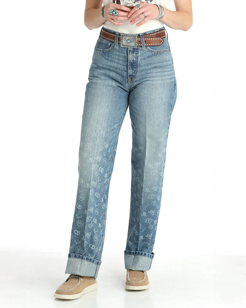 Person wearing blue jeans with decorative belt on a white background