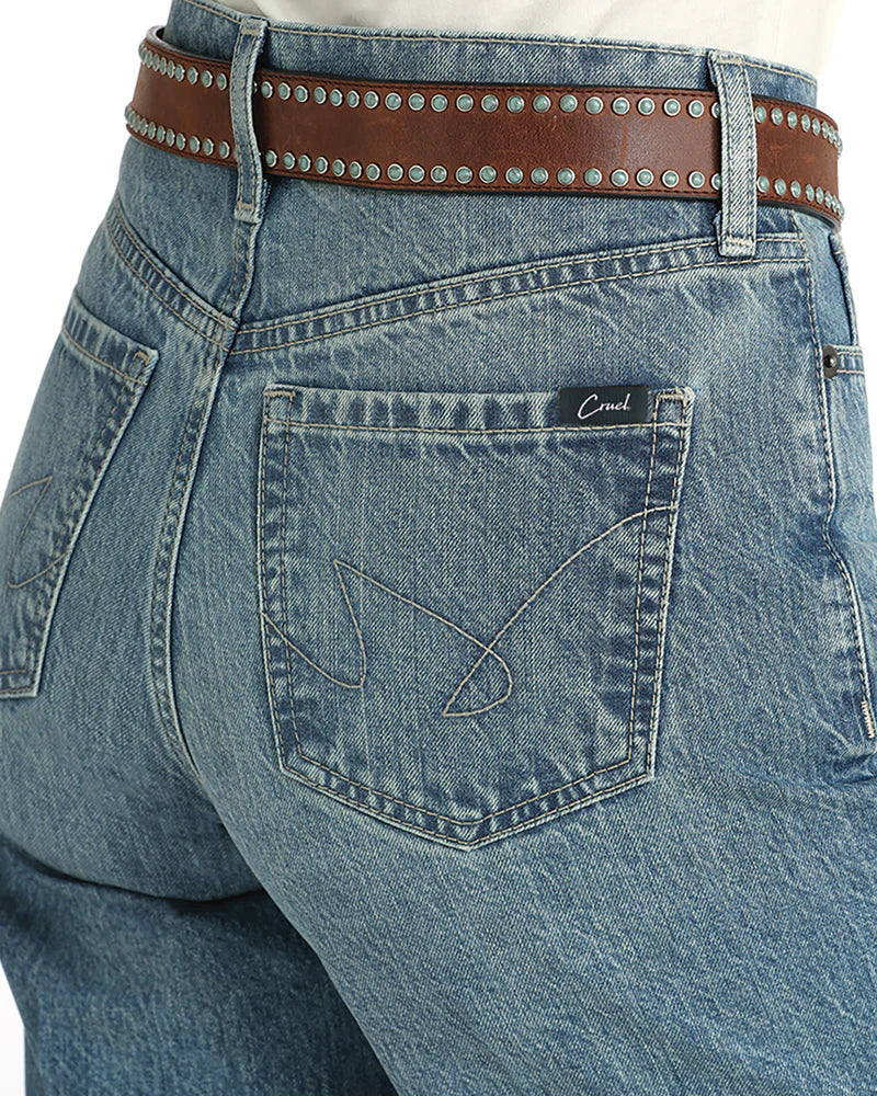 Close-up of blue jeans with a brown belt and 'Caval' brand label.