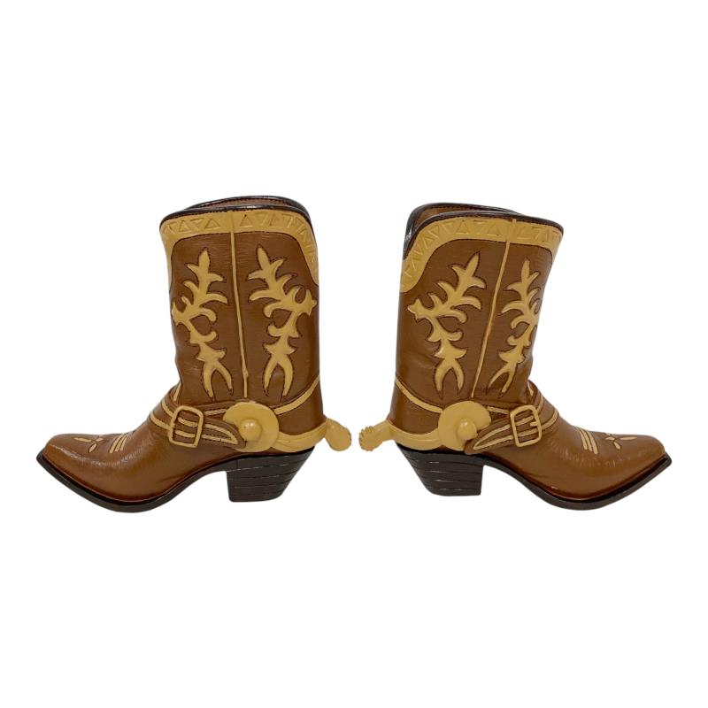 Pair of brown cowboy boots with decorative patterns on a white background