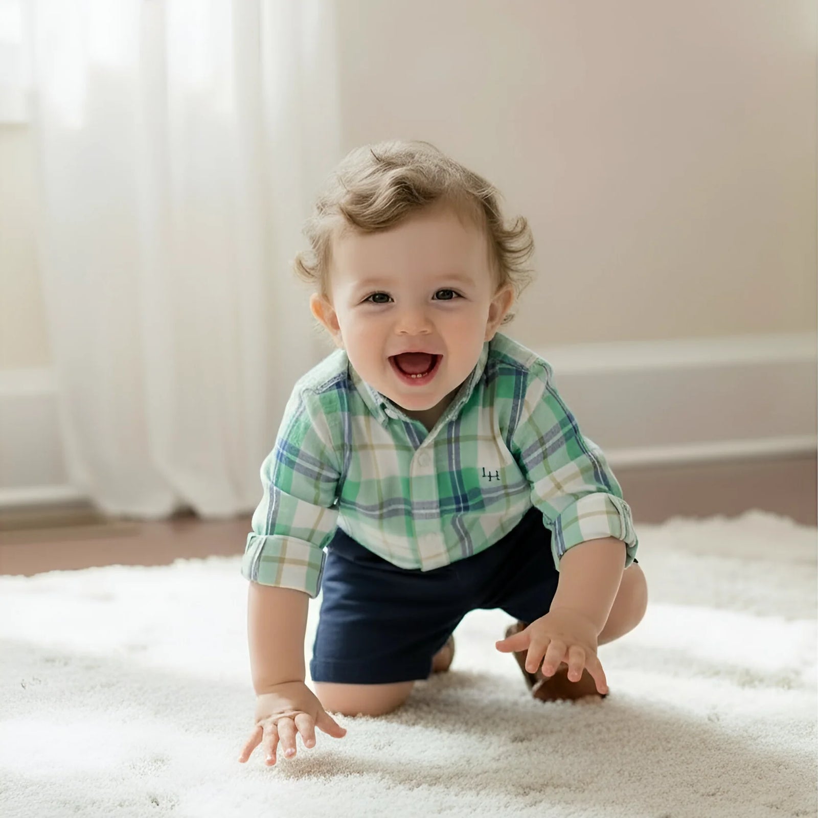 Child in a plaid shirt and dark shorts crawling on a carpeted floor.
