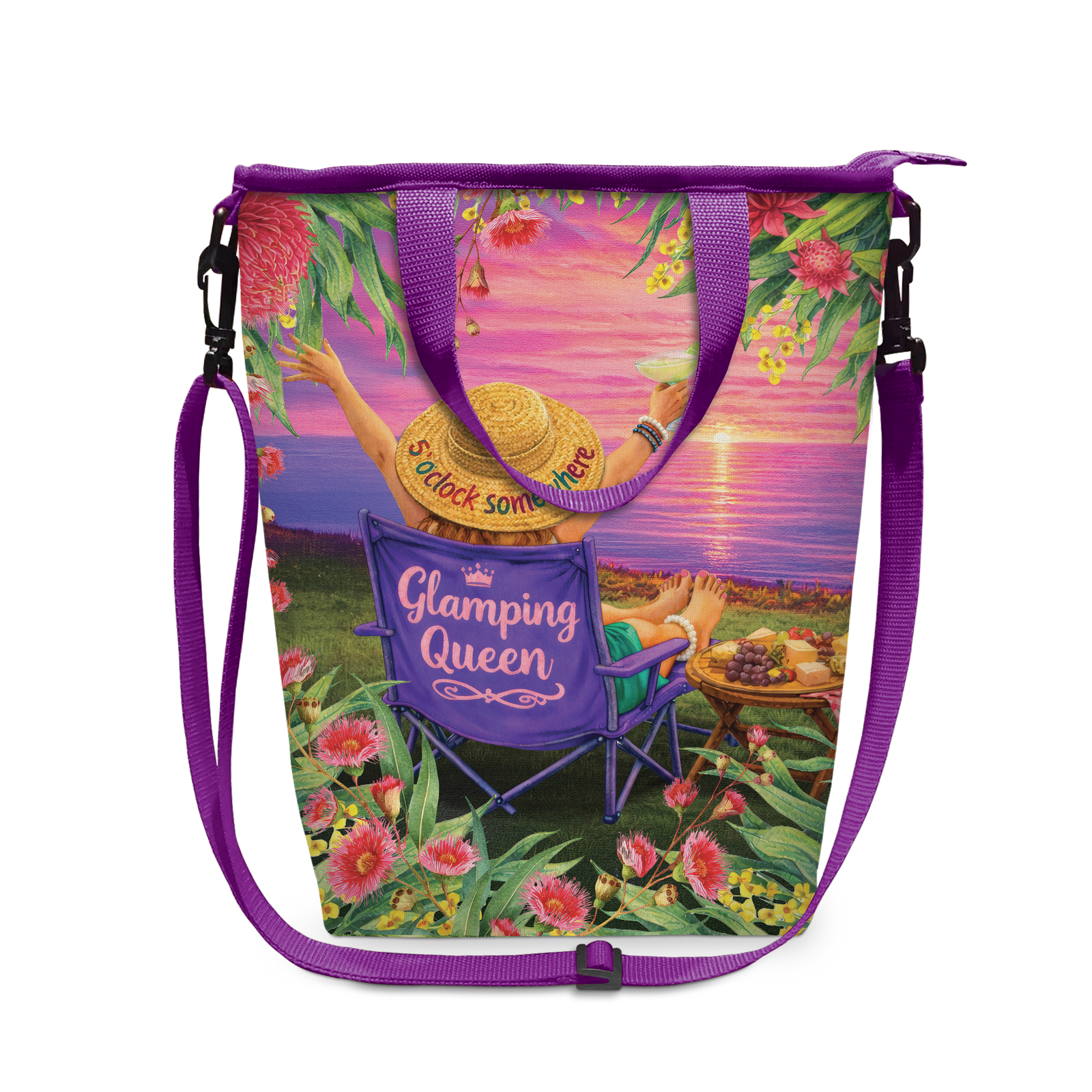 A purple tote bag with a colorful printed design of a woman relaxing by the ocean at sunset, featuring a purple shoulder strap and black plastic hardware.