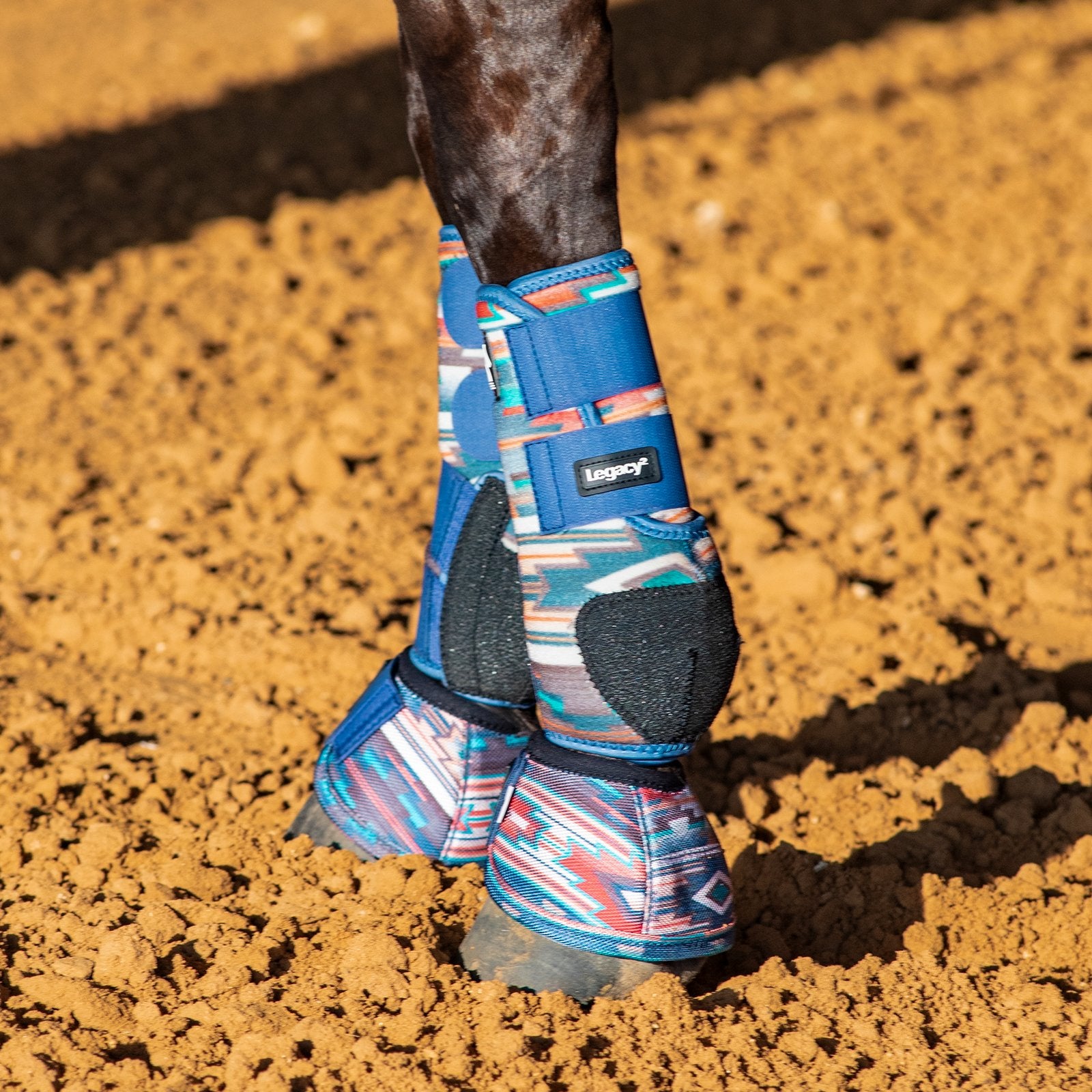 Classic Equine Legacy2 Pueblo Full Set Support Boots. Pair of protective horse boots with colorful pattern and blue straps on a white background