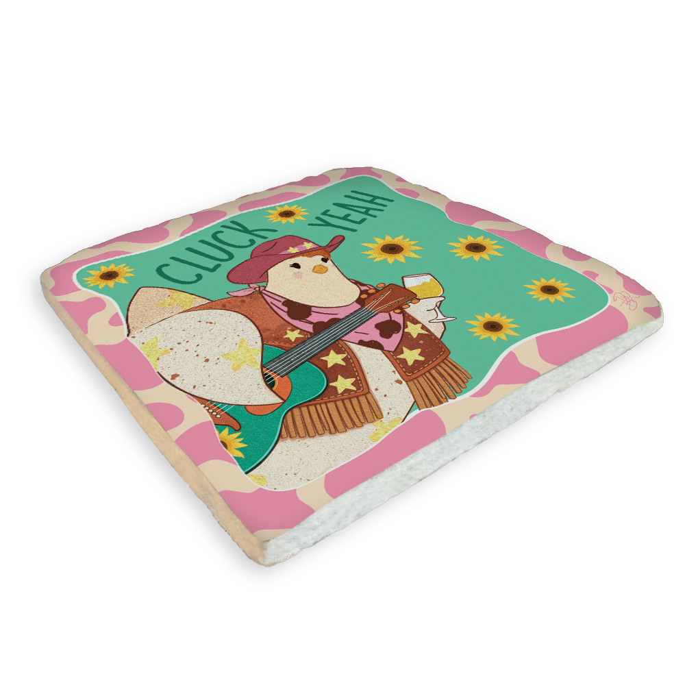 A square foam board or tray featuring a colorful western-style illustration of a penguin playing a guitar, with the text 'CLUCK YEAH' and pink camouflage-style border details, shown on a plain white background.